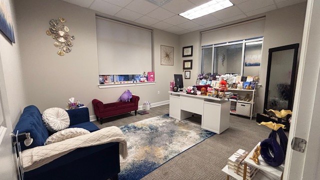 Elizabeth Macshadiya’s office, with the blue sofa, the armchair and the desk