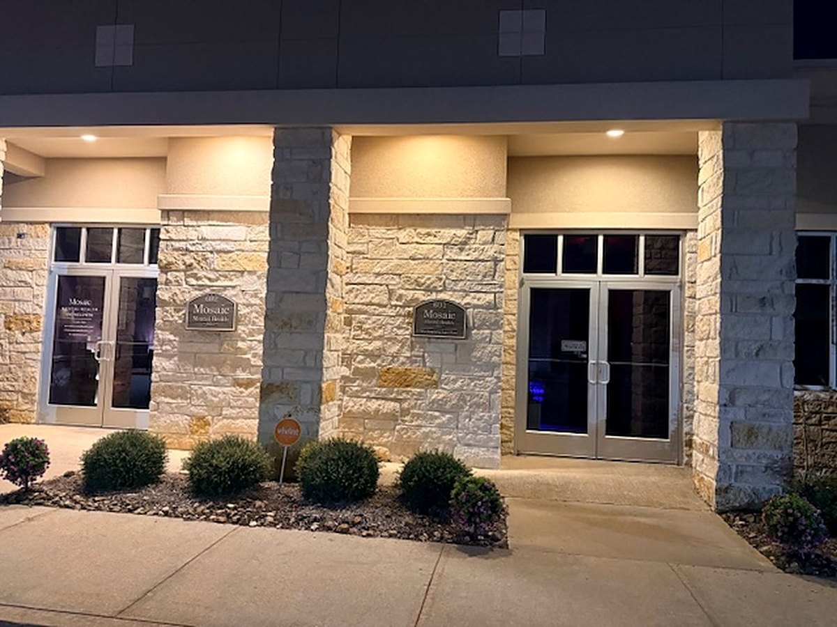 The lit entrance of the building in the evening