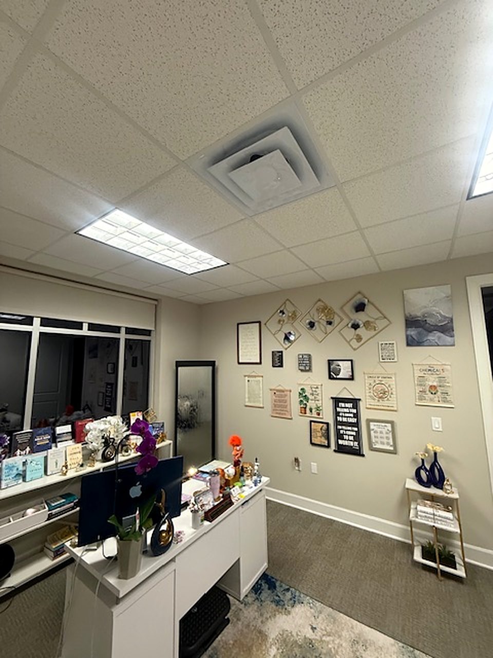 A consultation room with a gallery wall of framed quotes