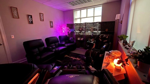 Recliners beside the woven screen, the blossom tree and the salt lamp