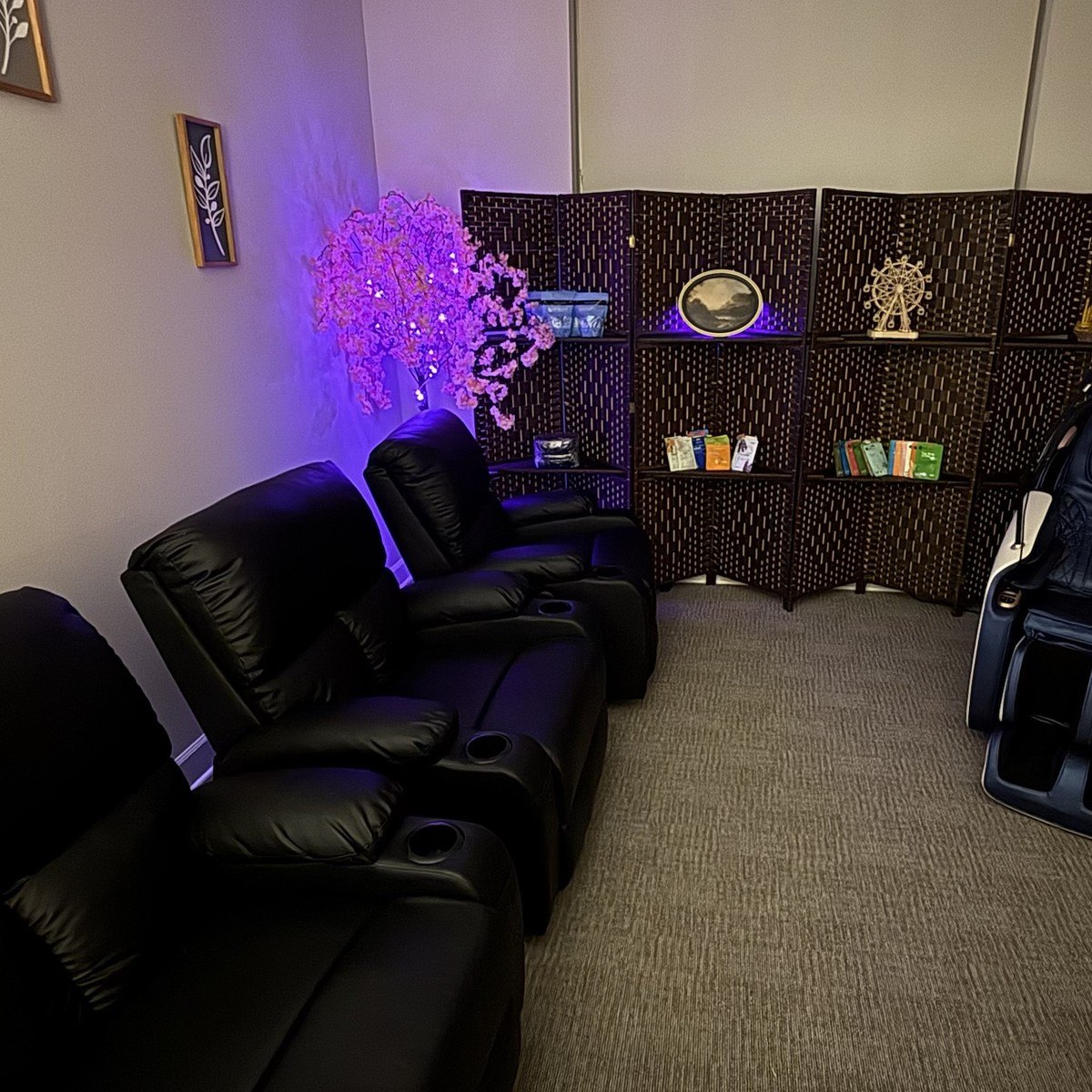 Relaxation Room recliners beside the woven screen and blossom tree
